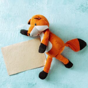 Square mockup for a kraft card with a toy fox. A greeting card or invitation