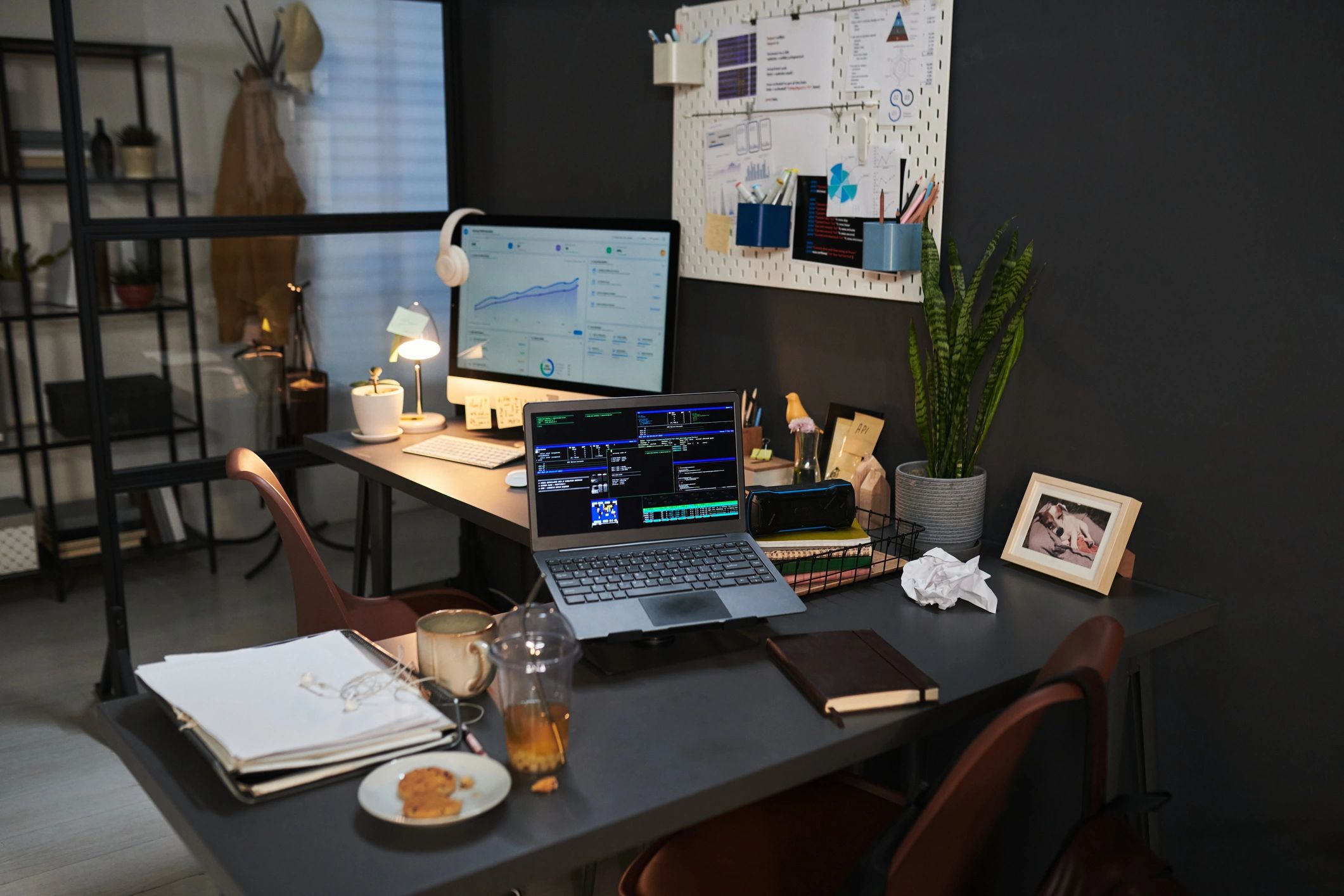 Dark software analytics dashboard on a modern workspace screen